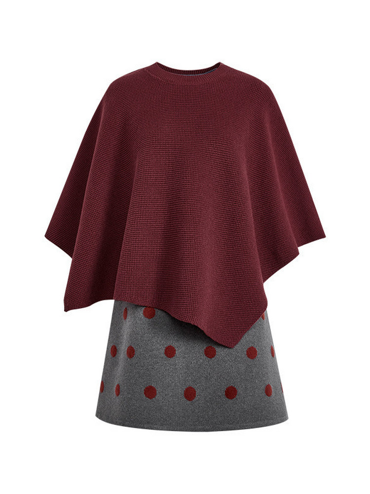 Burgundy poncho-style knit top with a gray polka dot skirt