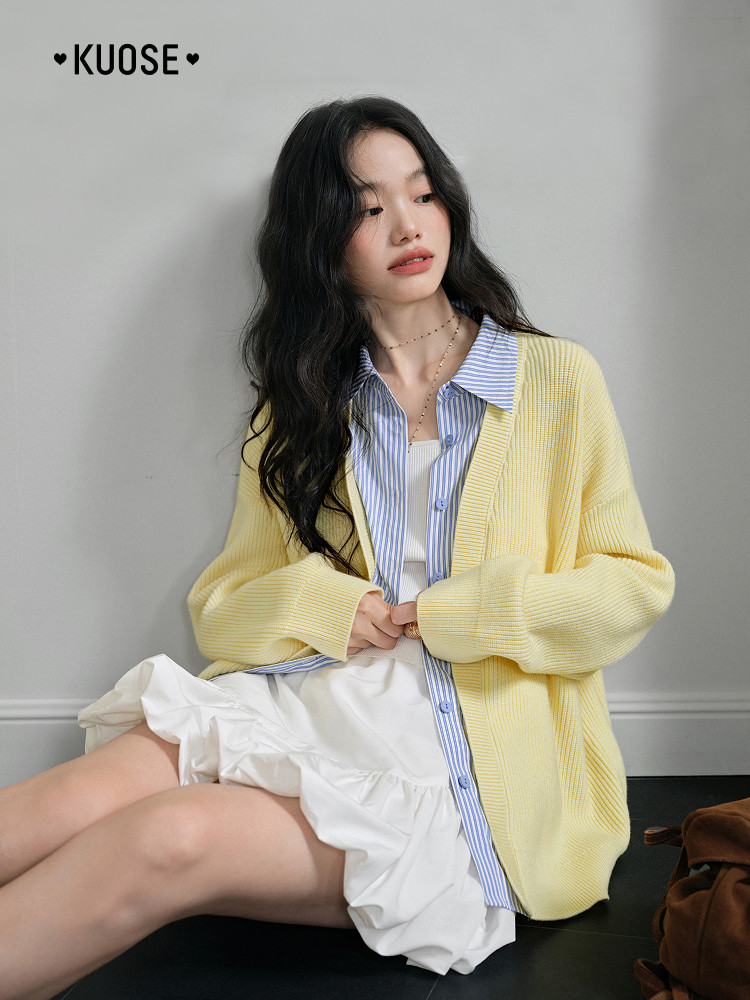 Model wearing a pale yellow cardigan over a striped shirt and white ruffled dress