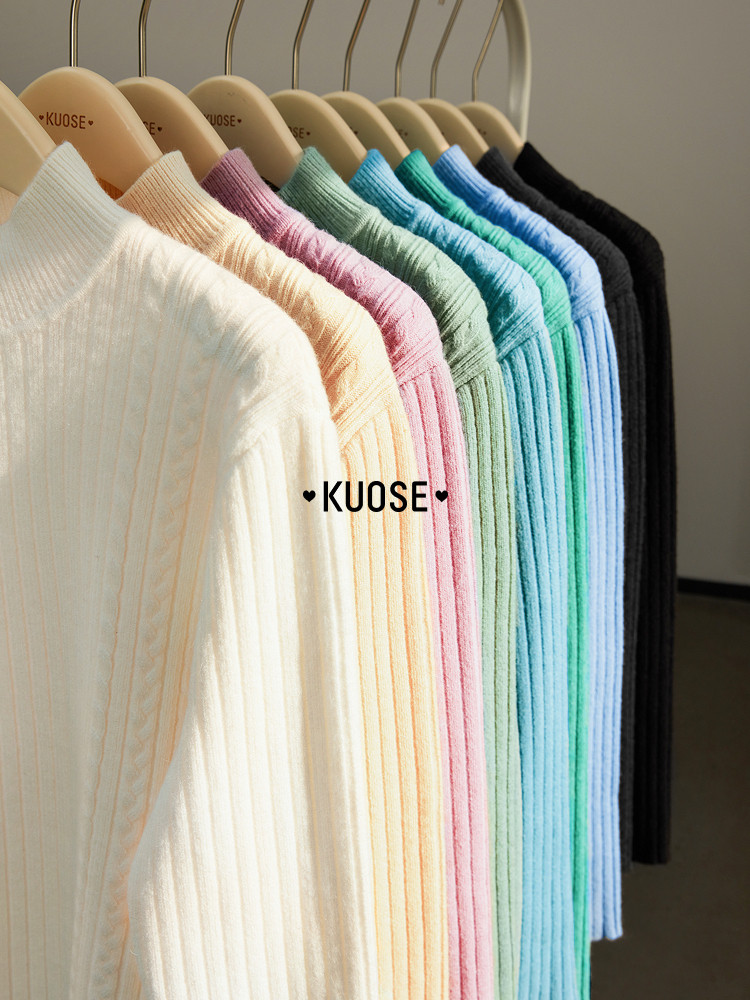 Pastel ribbed knit sweaters on hanging display