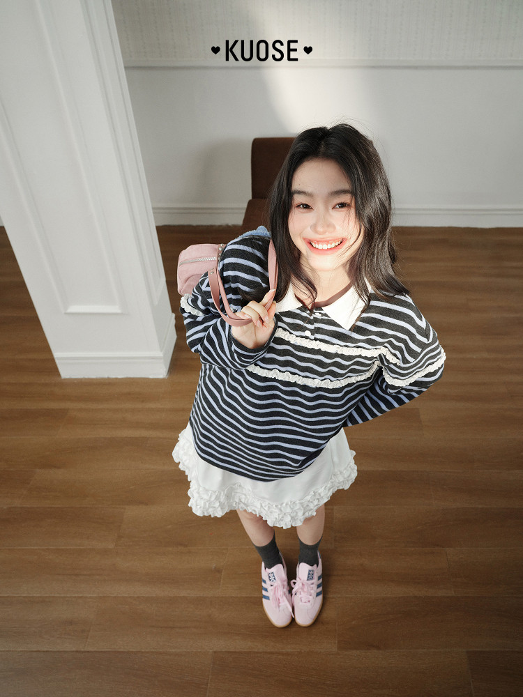 Model wearing a striped sweater with a white ruffled skirt and pink sneakers