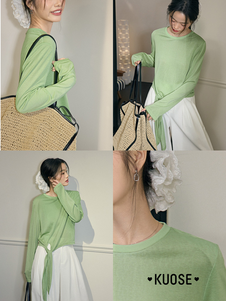 Model wearing a light green long-sleeve top with a white skirt and straw tote bag