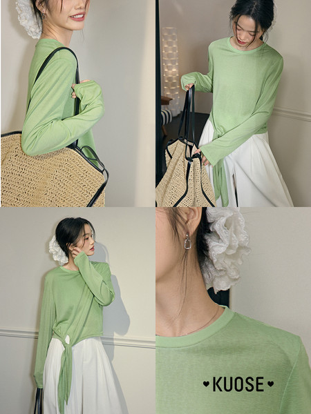 Model wearing a light green long-sleeve top with a white skirt and straw tote bag