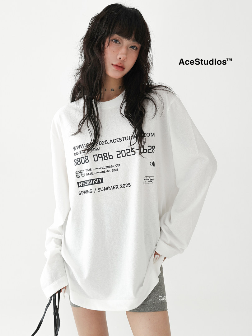 Model wearing a white graphic long-sleeve oversized shirt