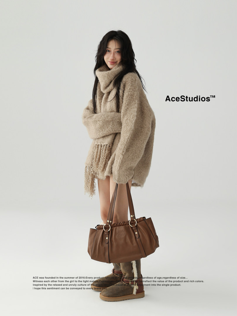 Brown leather shoulder tote bag worn by a model