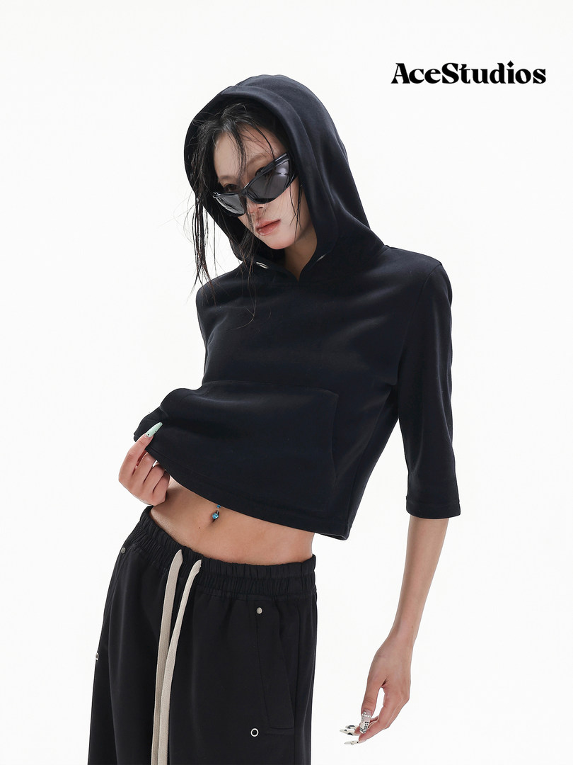 Model wearing a black cropped hoodie and black jogger pants