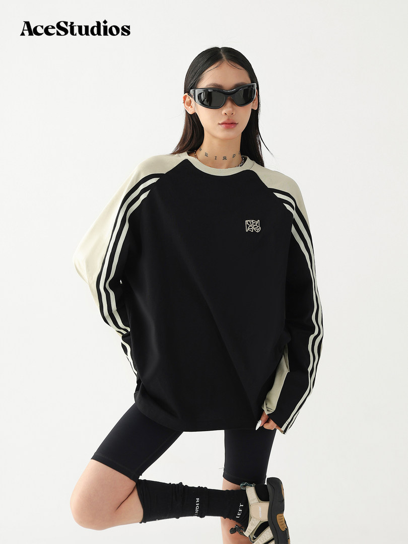 Black and white oversized striped long-sleeve top worn by a model