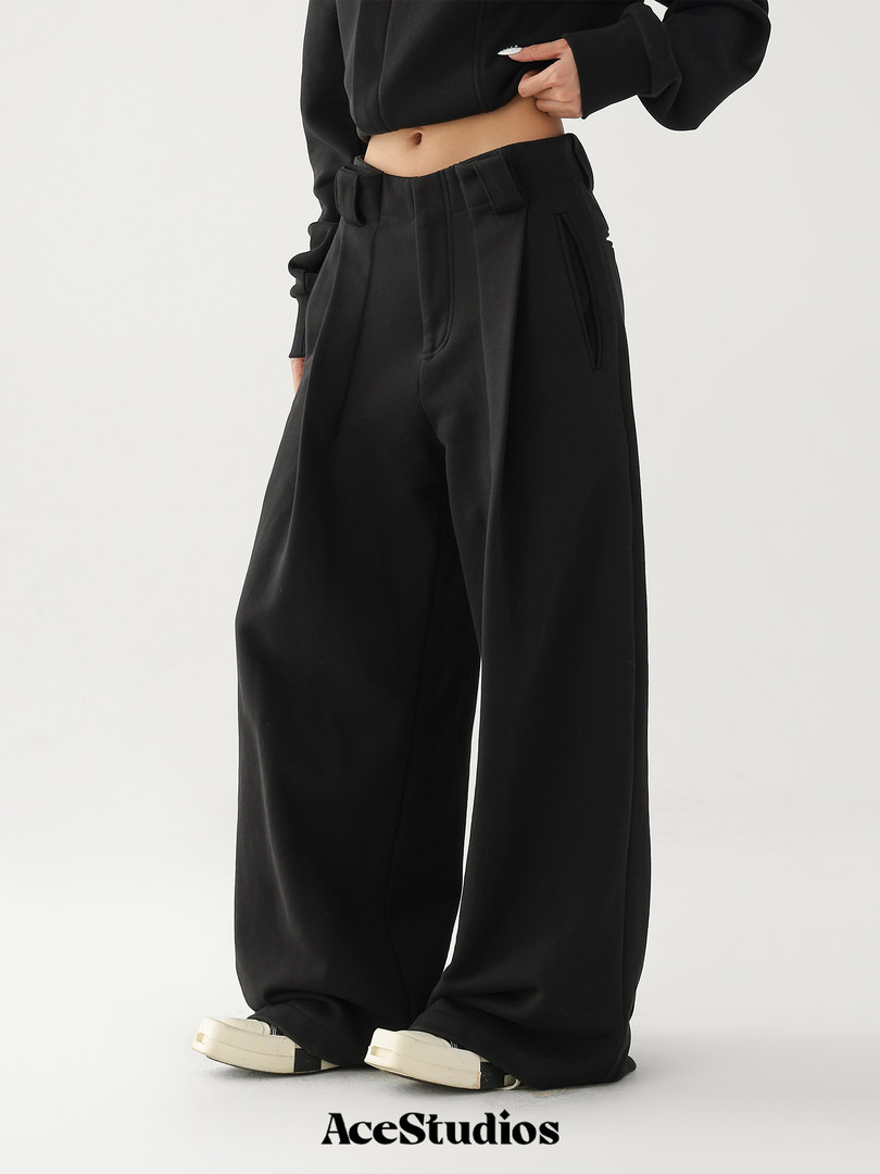 Black wide-leg pants worn by a model with a cropped top