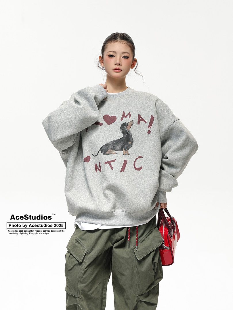Model wearing a gray oversized graphic sweatshirt with cargo pants and a red handbag