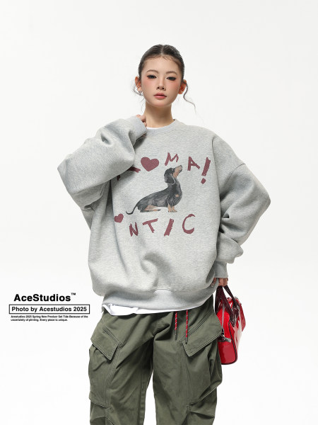 Model wearing a gray oversized graphic sweatshirt with cargo pants and a red handbag
