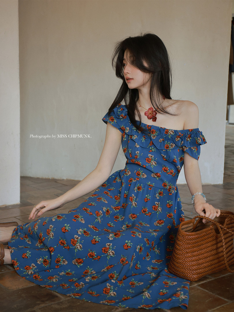 Blue floral off-shoulder dress worn by a model