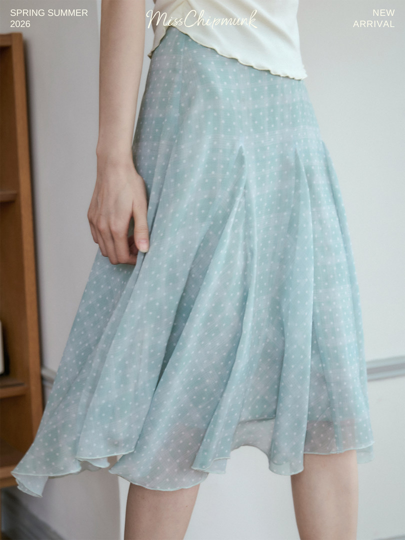 Light blue polka dot skirt worn by a model with promotional text overlay
