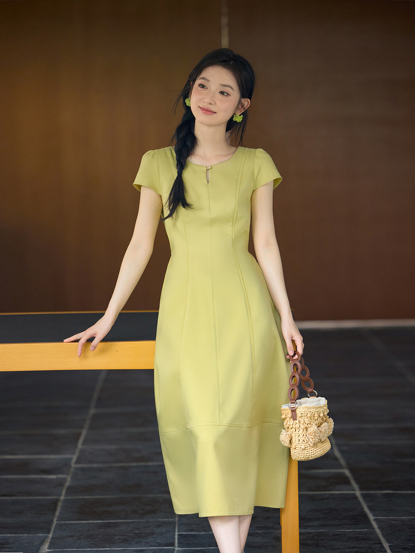 Model wearing a light green midi dress with short sleeves