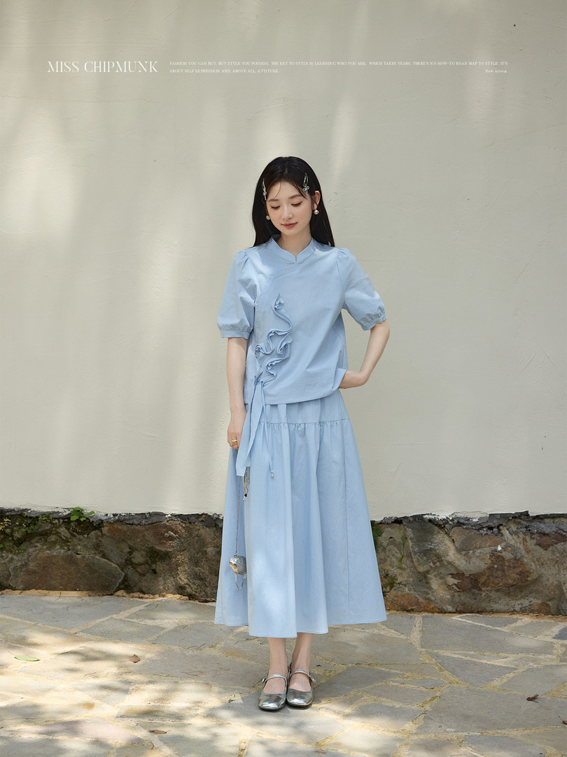 Light blue two-piece dress outfit worn by a model outdoors