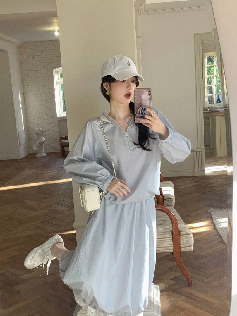Light blue oversized hooded dress set worn with a white cap and sneakers