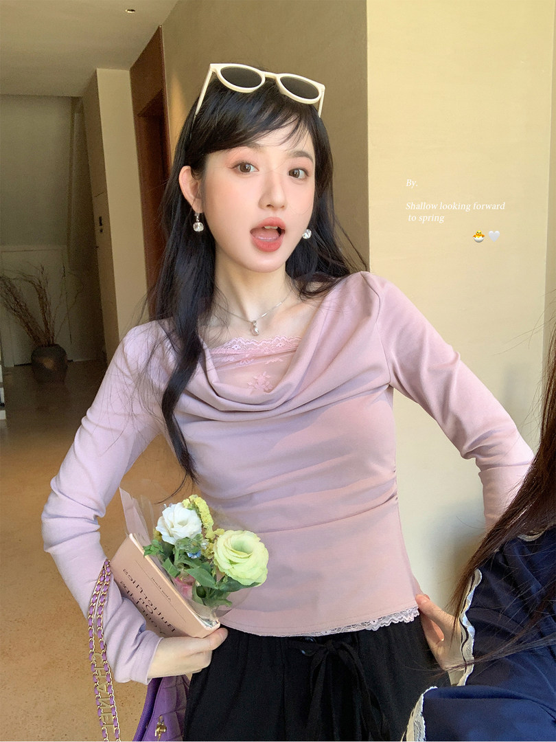 Model wearing a light pink long-sleeve draped top with lace trim