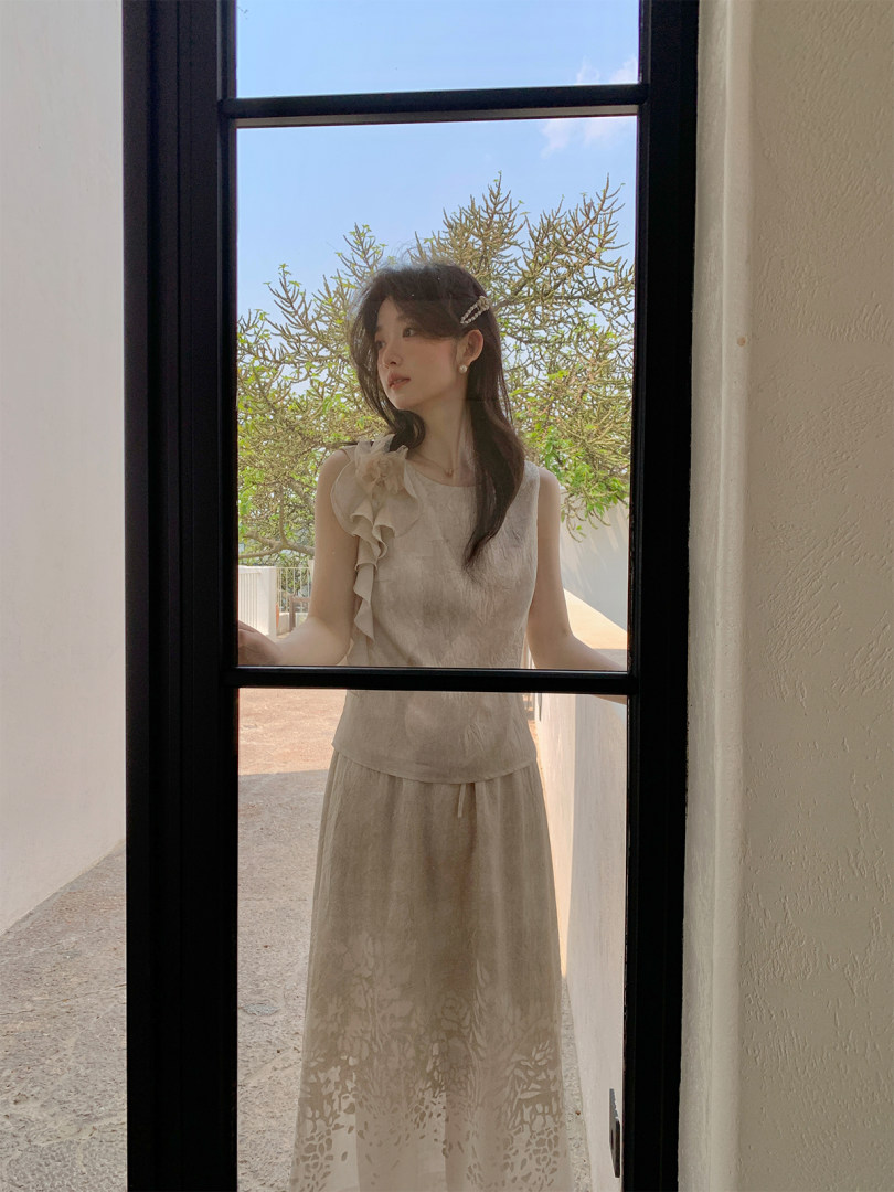 Beige sleeveless dress worn by a model outdoors
