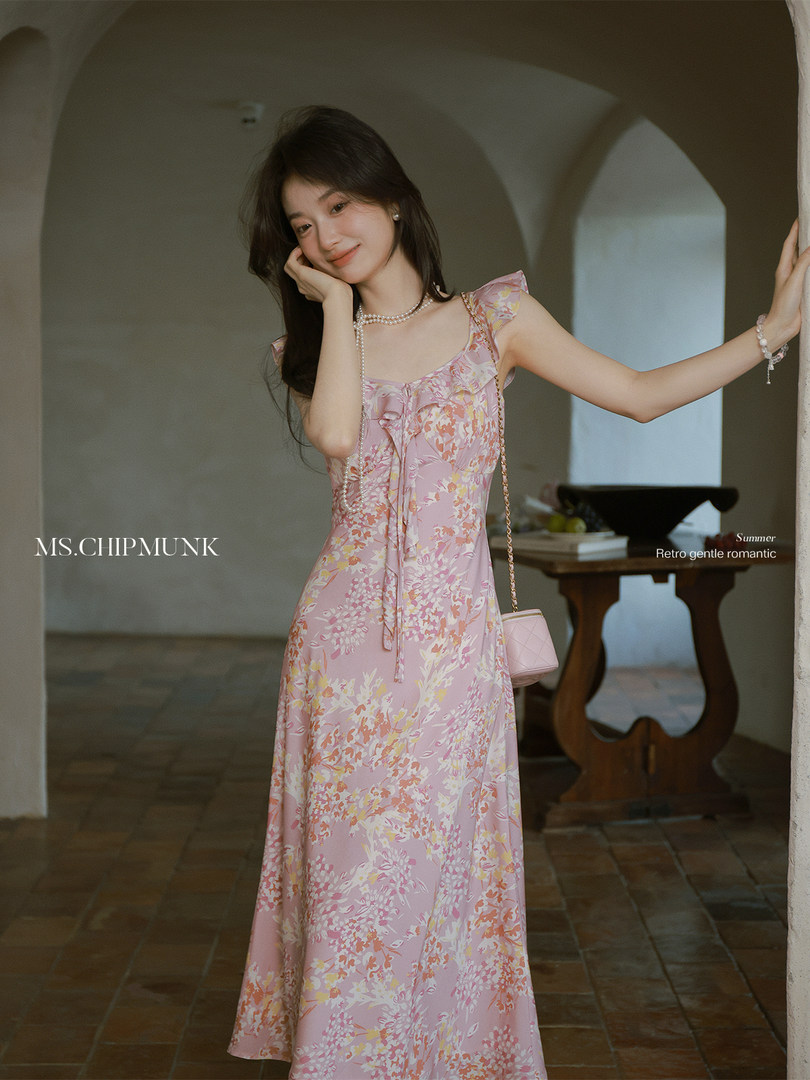 Model wearing a pink floral maxi dress with a retro romantic style