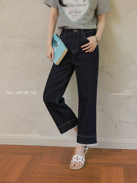Model wearing dark wide-leg denim pants with a grey graphic T-shirt