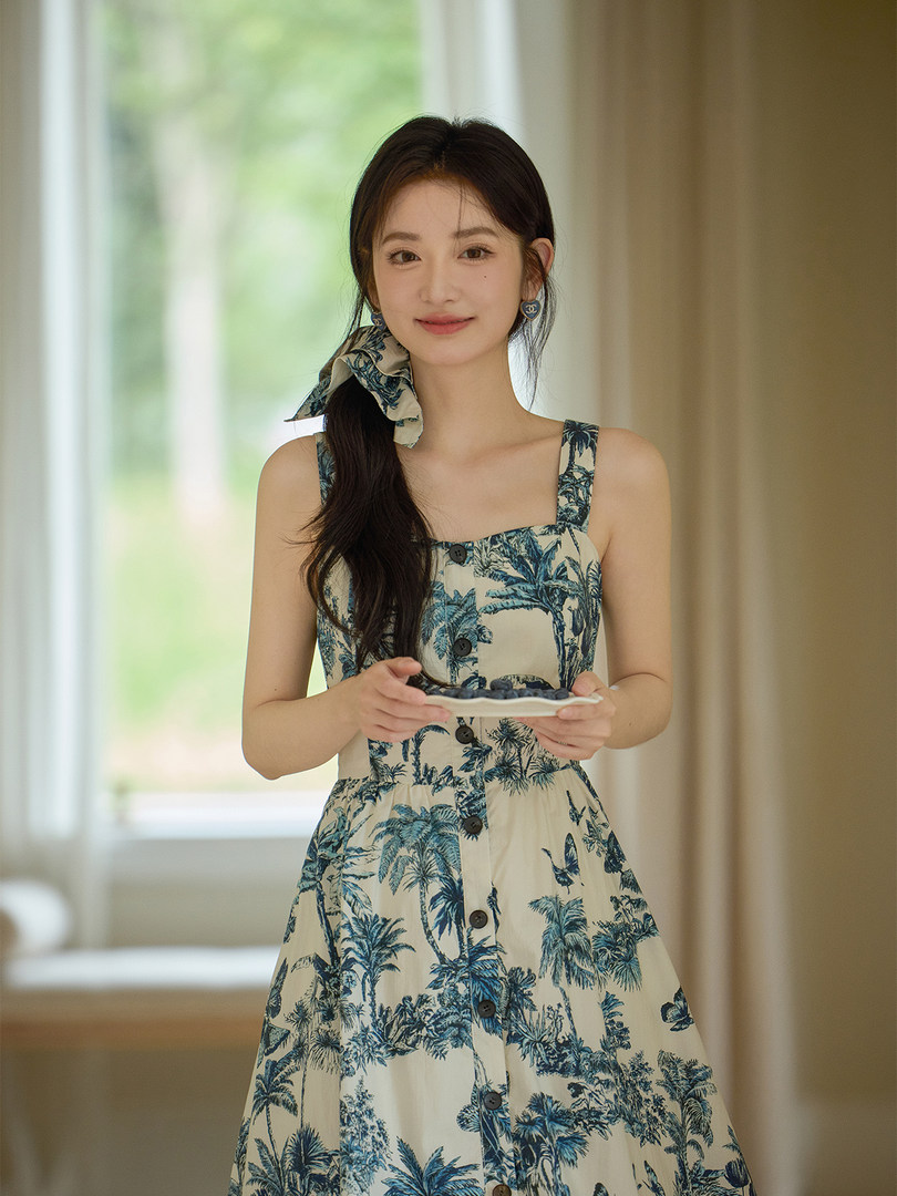 Woman wearing a tropical printed sleeveless dress