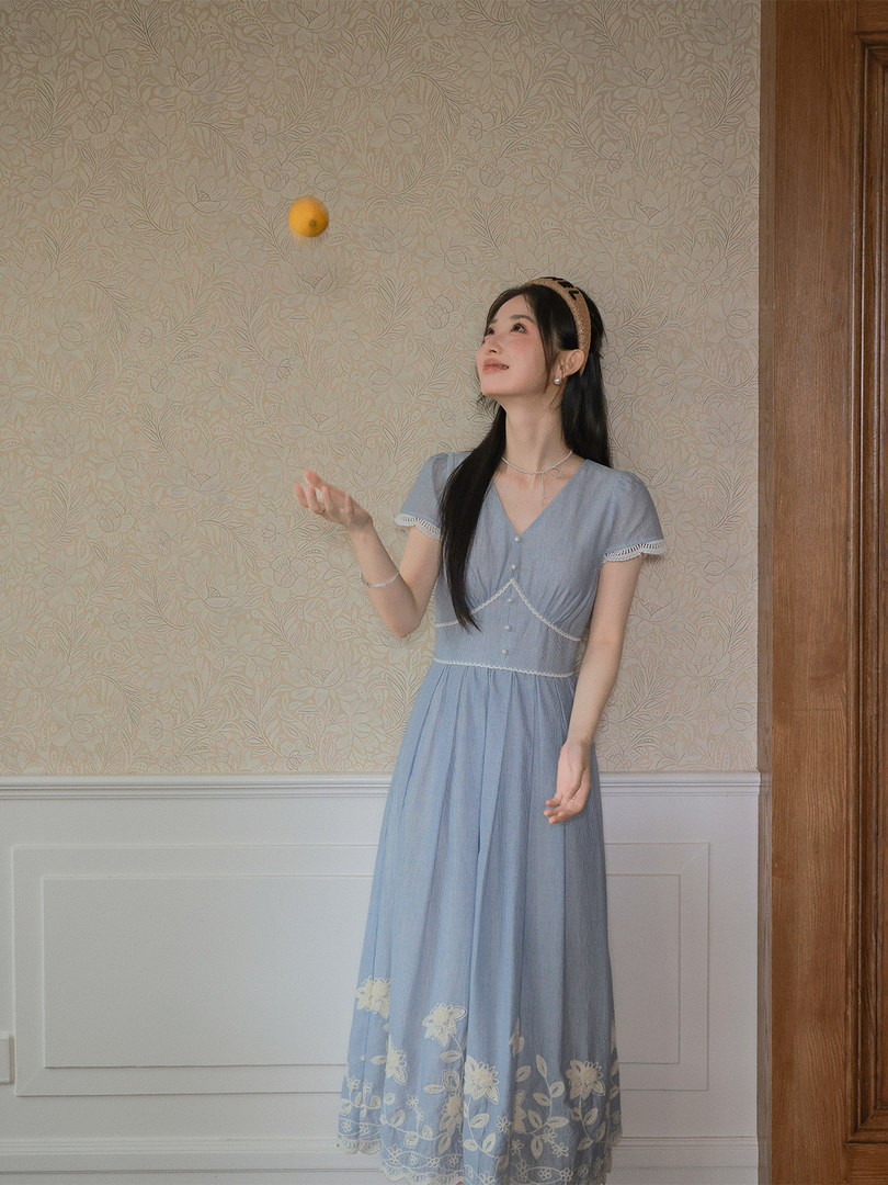 Light blue floral dress worn by a model indoors