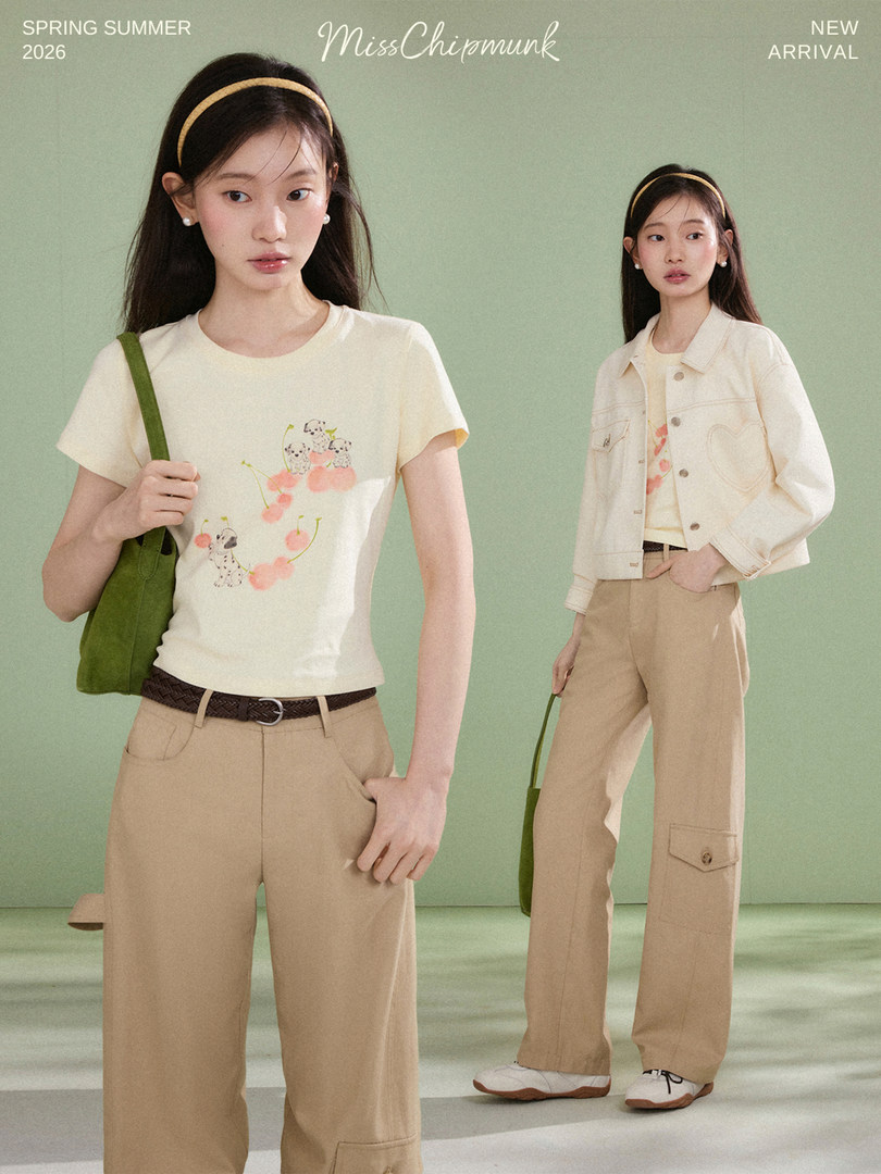 Fashion model wearing a cream graphic tee and beige pants in a spring/summer new arrival promo image