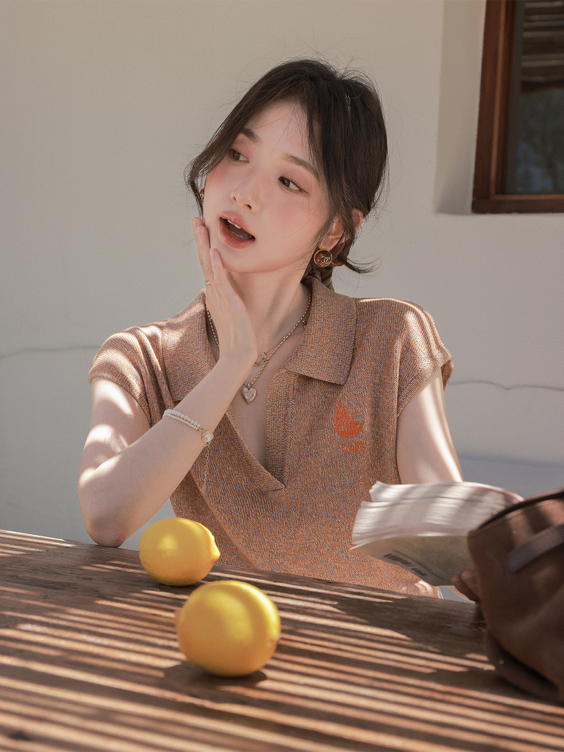 Woman wearing a short-sleeve knit polo top in a warm brown tone
