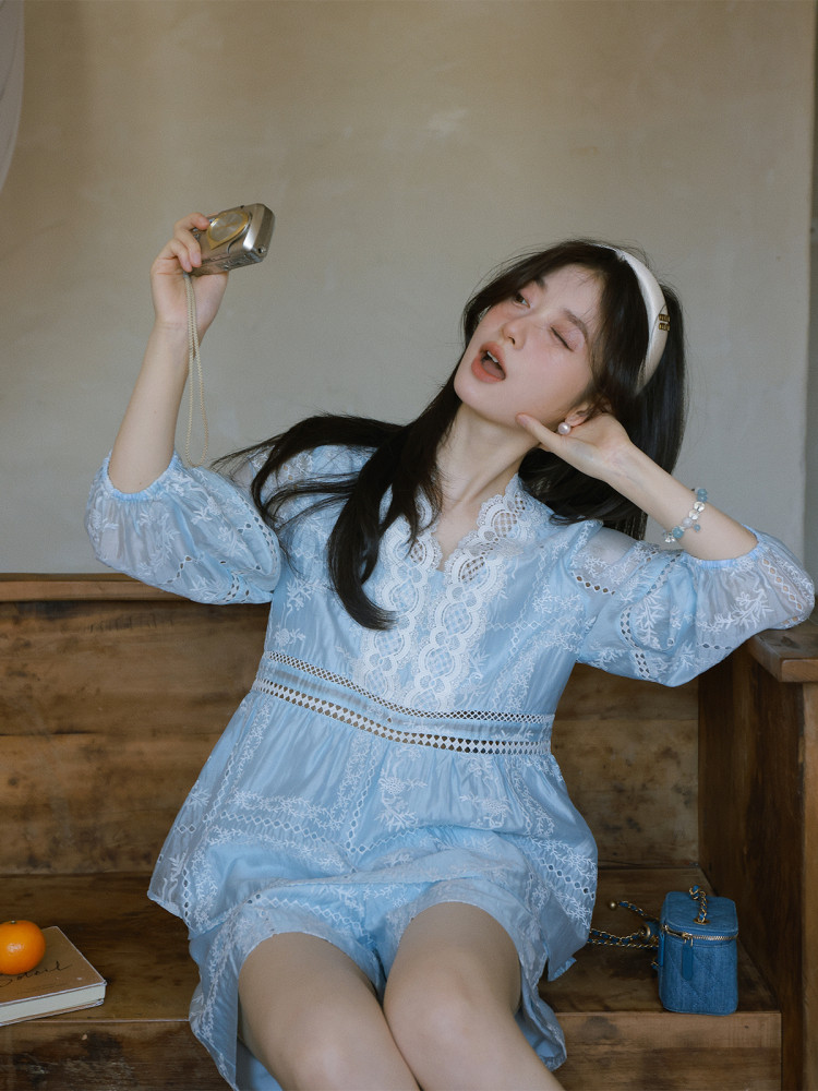 Woman wearing a light blue lace dress