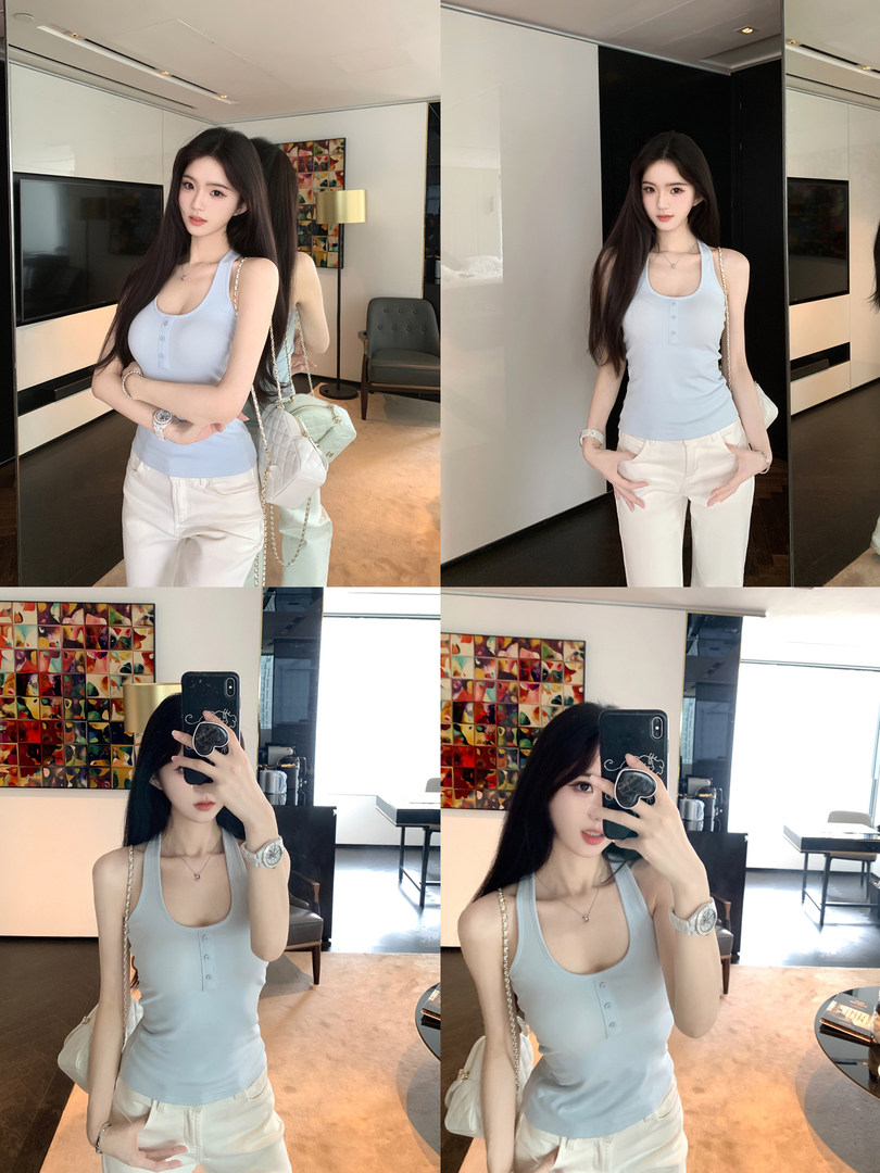 Model wearing a light blue sleeveless top with white pants in a modern interior setting