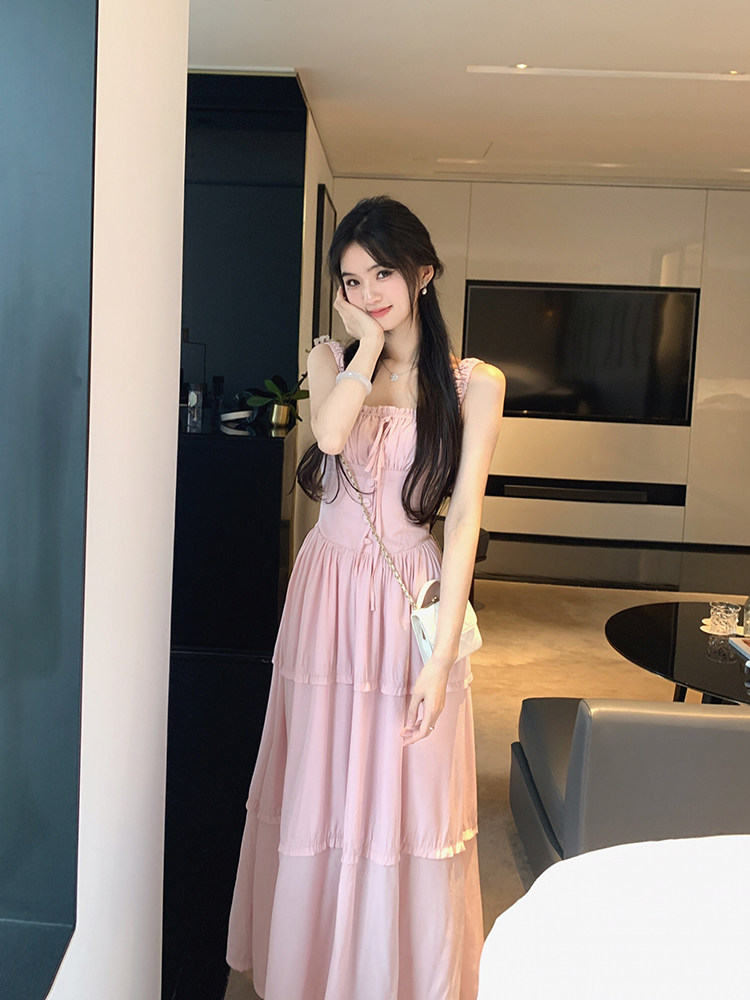 Woman wearing a pink tiered dress in a modern living room