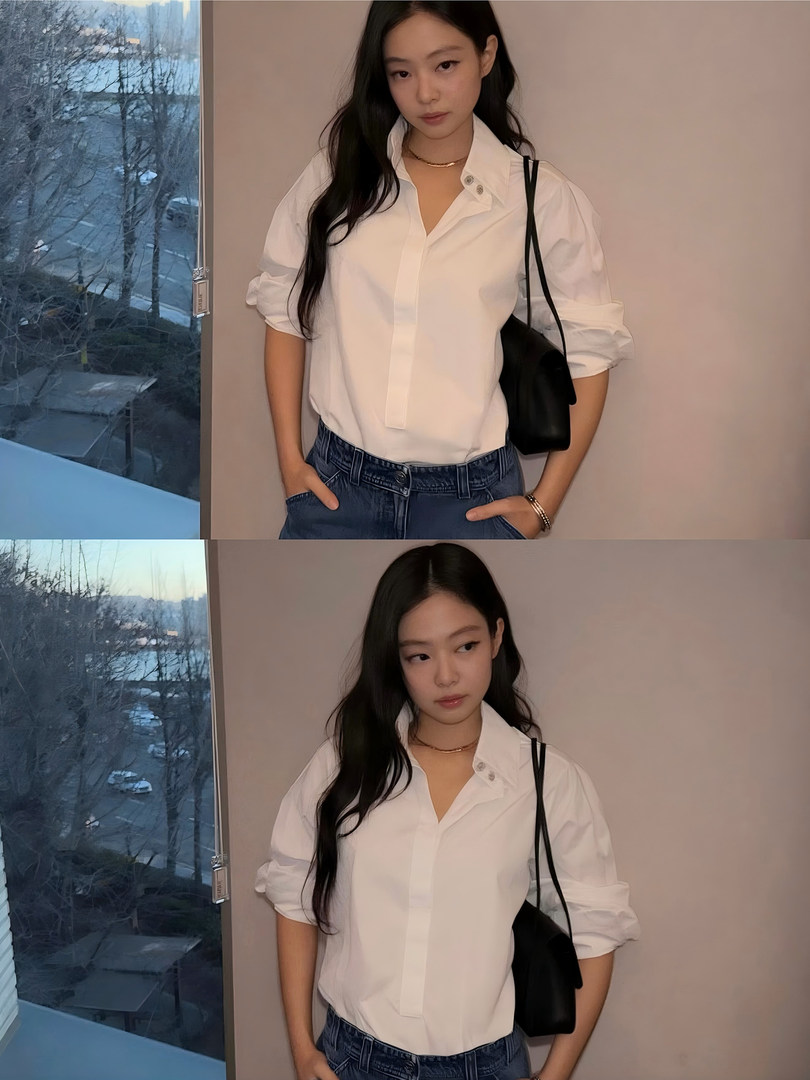 Woman wearing a white button-up shirt and blue jeans, posing indoors near a window.