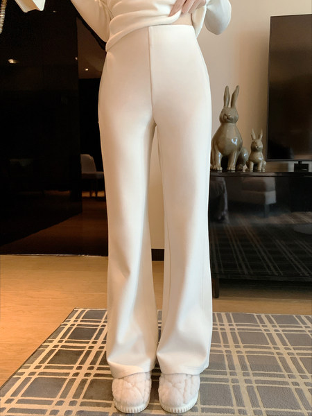 White wide-leg pants worn by a model indoors with slippers