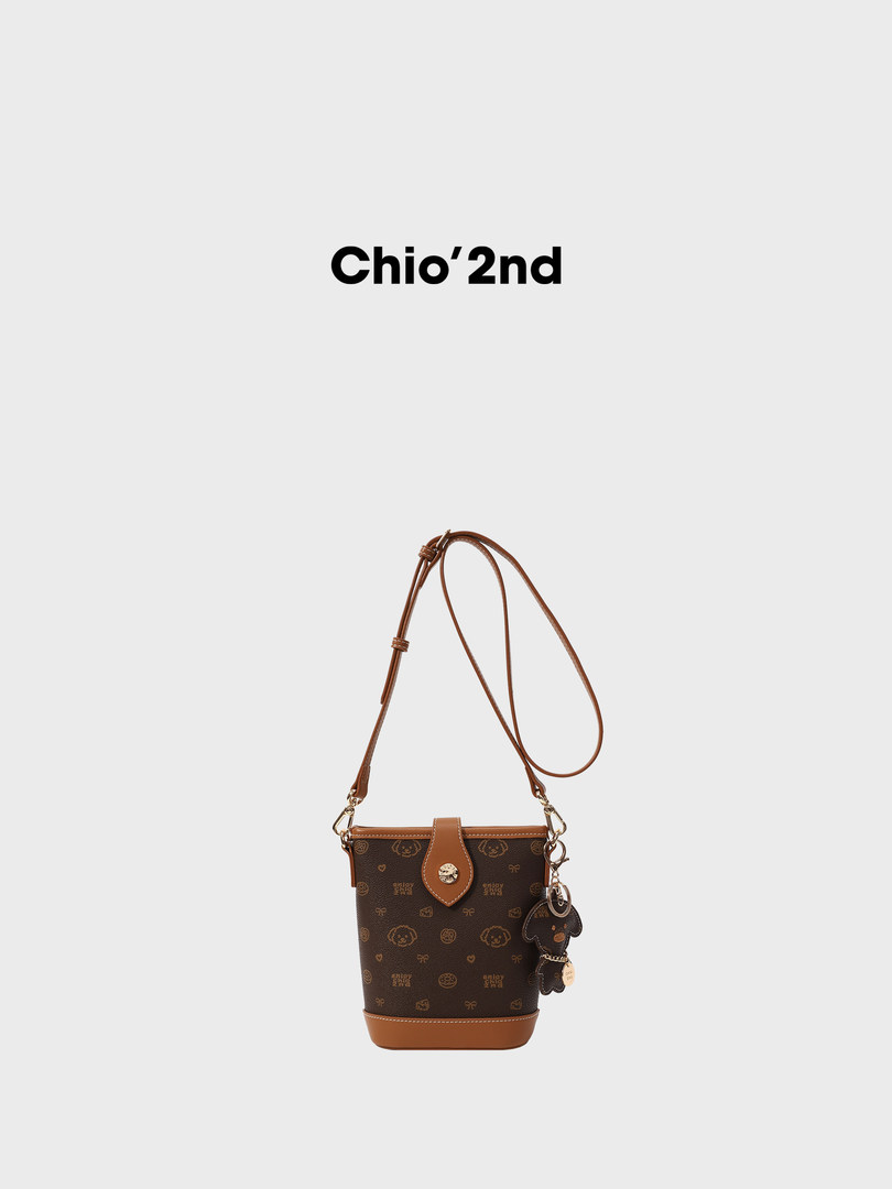 Brown monogram crossbody bucket bag with long strap and charm