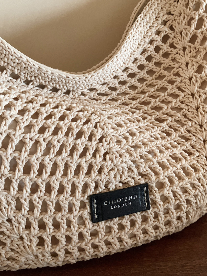Beige woven crochet tote bag with brand label