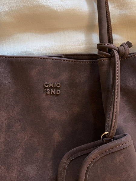 Brown leather tote bag with branded logo and shoulder strap