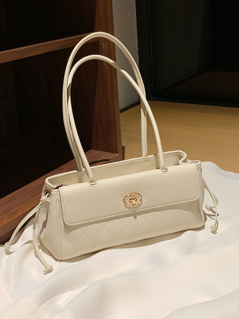 Cream white quilted handbag with gold clasp and top handles