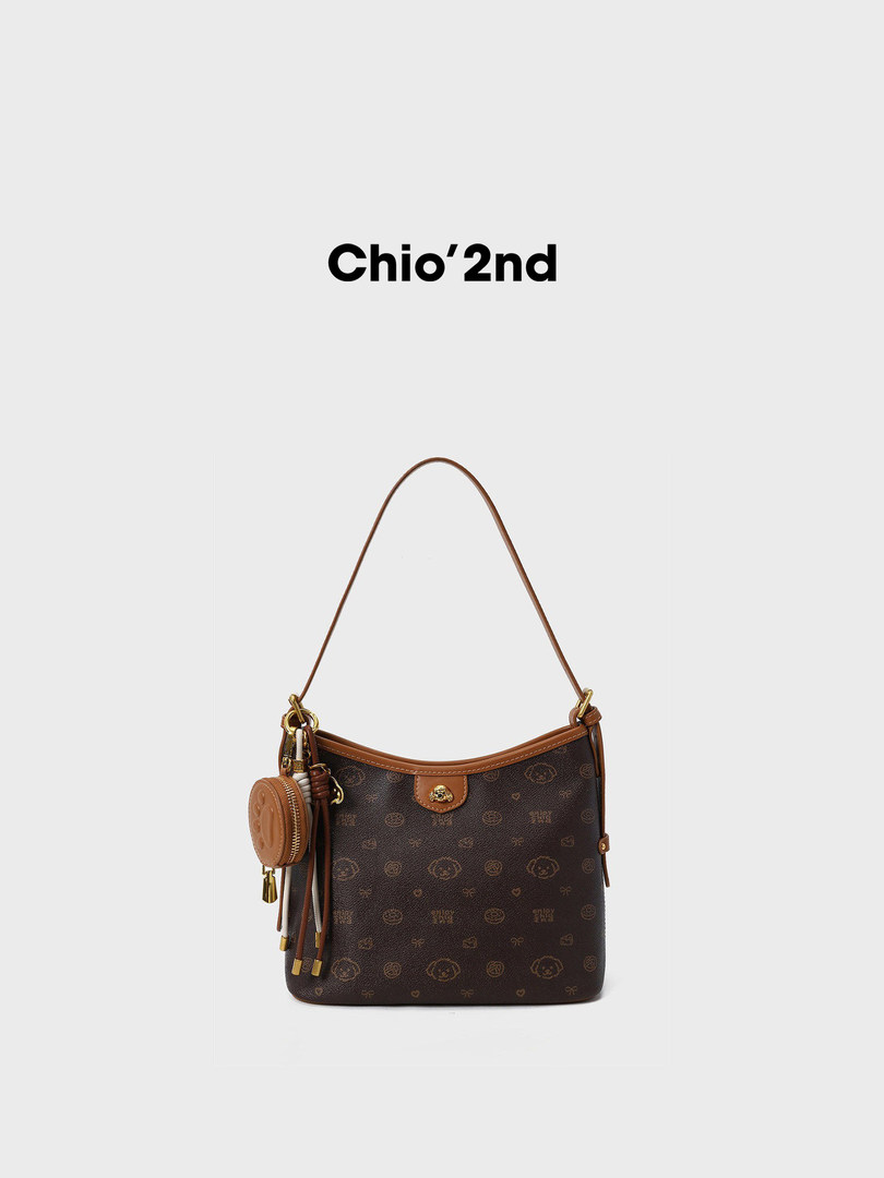 Brown monogram shoulder handbag with a small matching charm on a white background