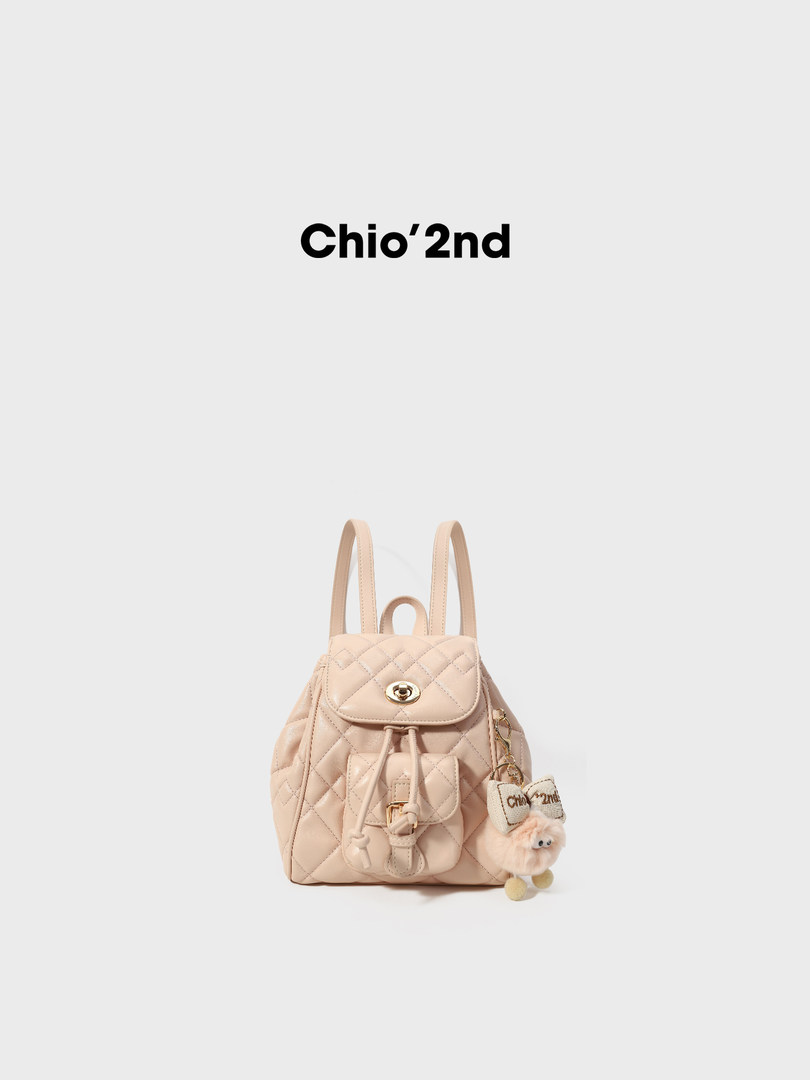 Beige quilted backpack with front pocket and charm accessory