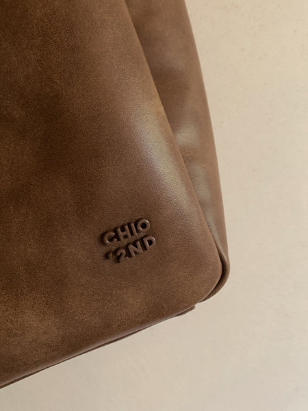Brown leather handbag with embossed logo detail