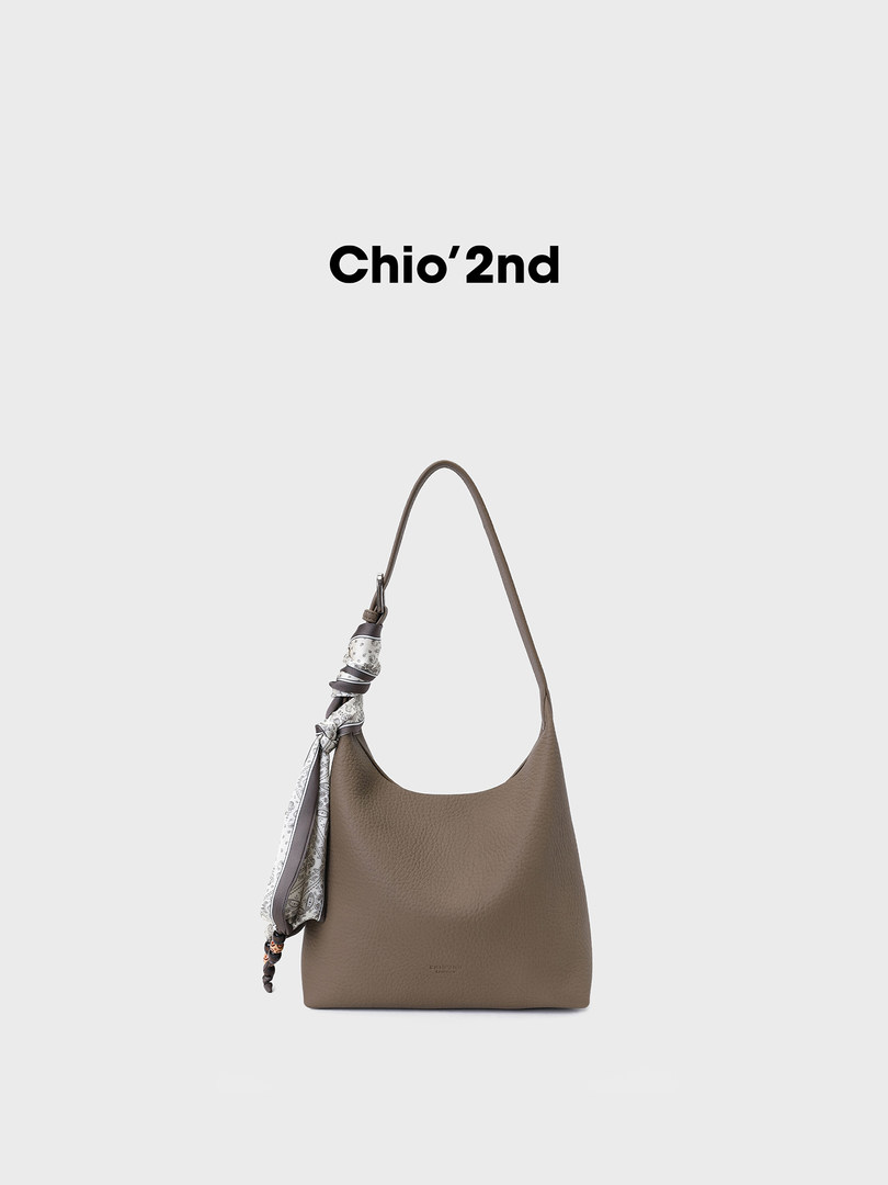 Taupe leather shoulder bag with a scarf accent on a plain background
