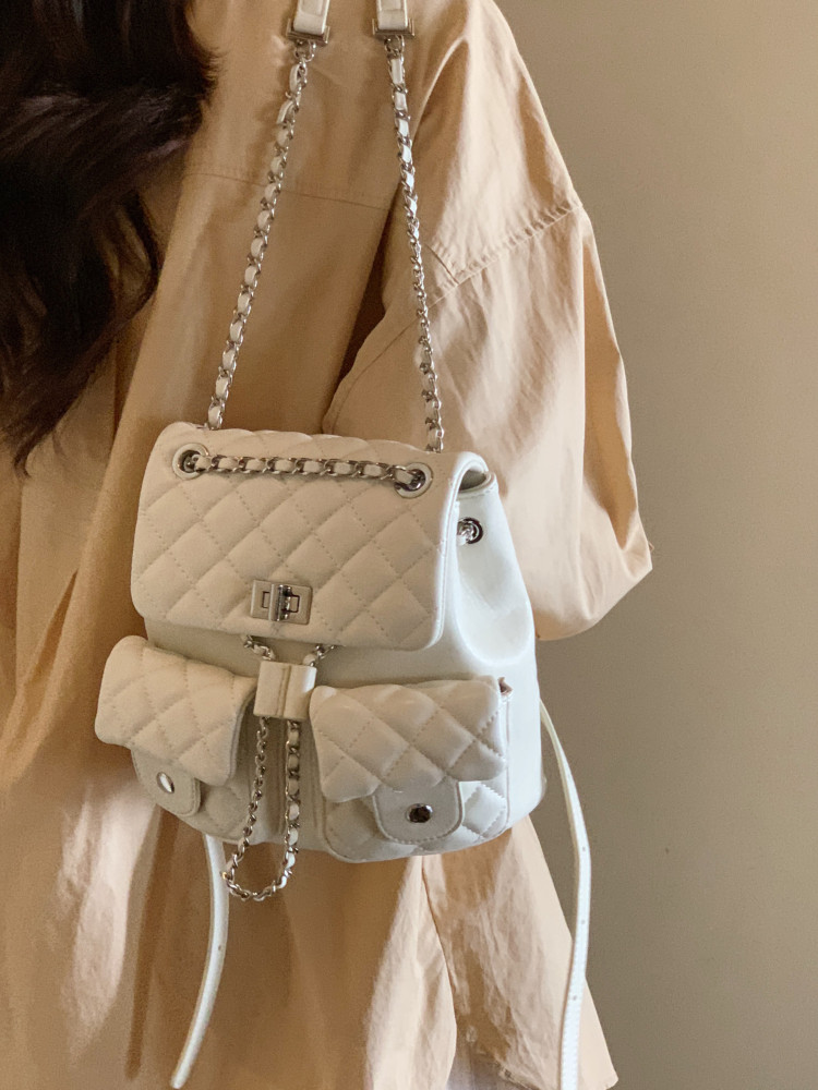 White quilted chain-strap handbag worn on a beige outfit