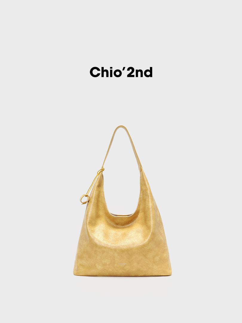 Gold hobo shoulder bag on a plain white background