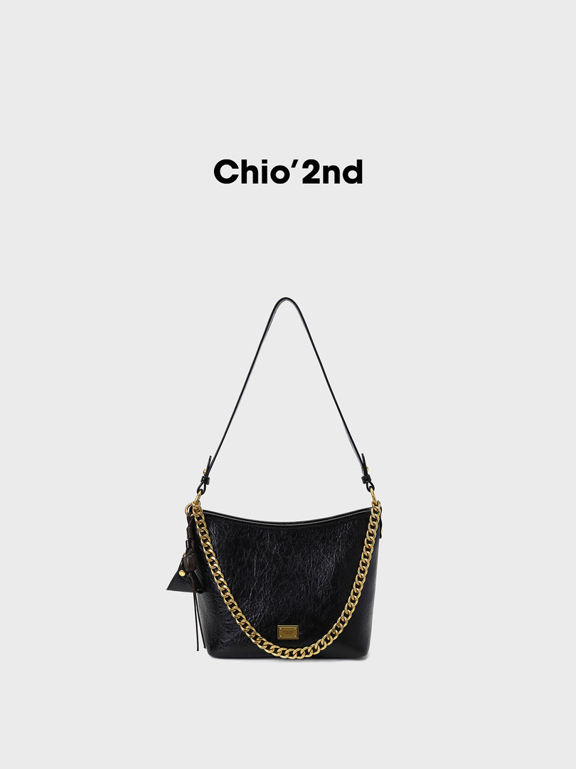 Black leather shoulder handbag with gold chain detail on a white background