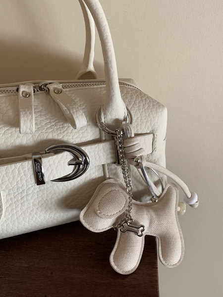 Cream textured handbag with silver hardware and dog charm