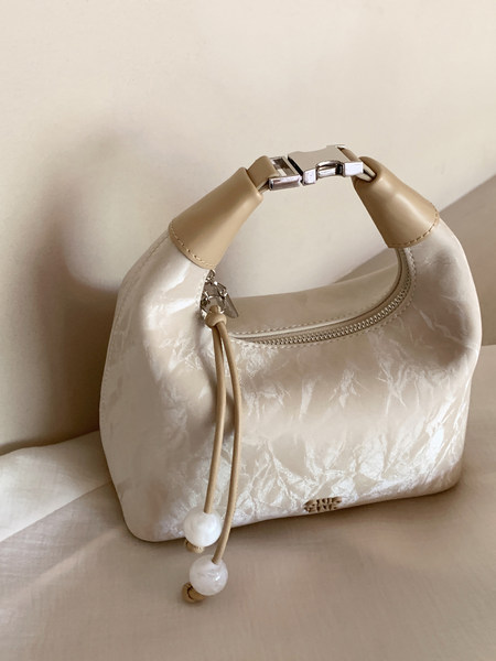 Cream and beige structured handbag with silver hardware and beaded drawstring detail