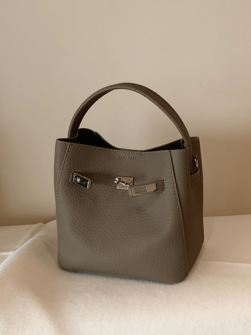 Gray structured leather handbag with top handle and metal hardware