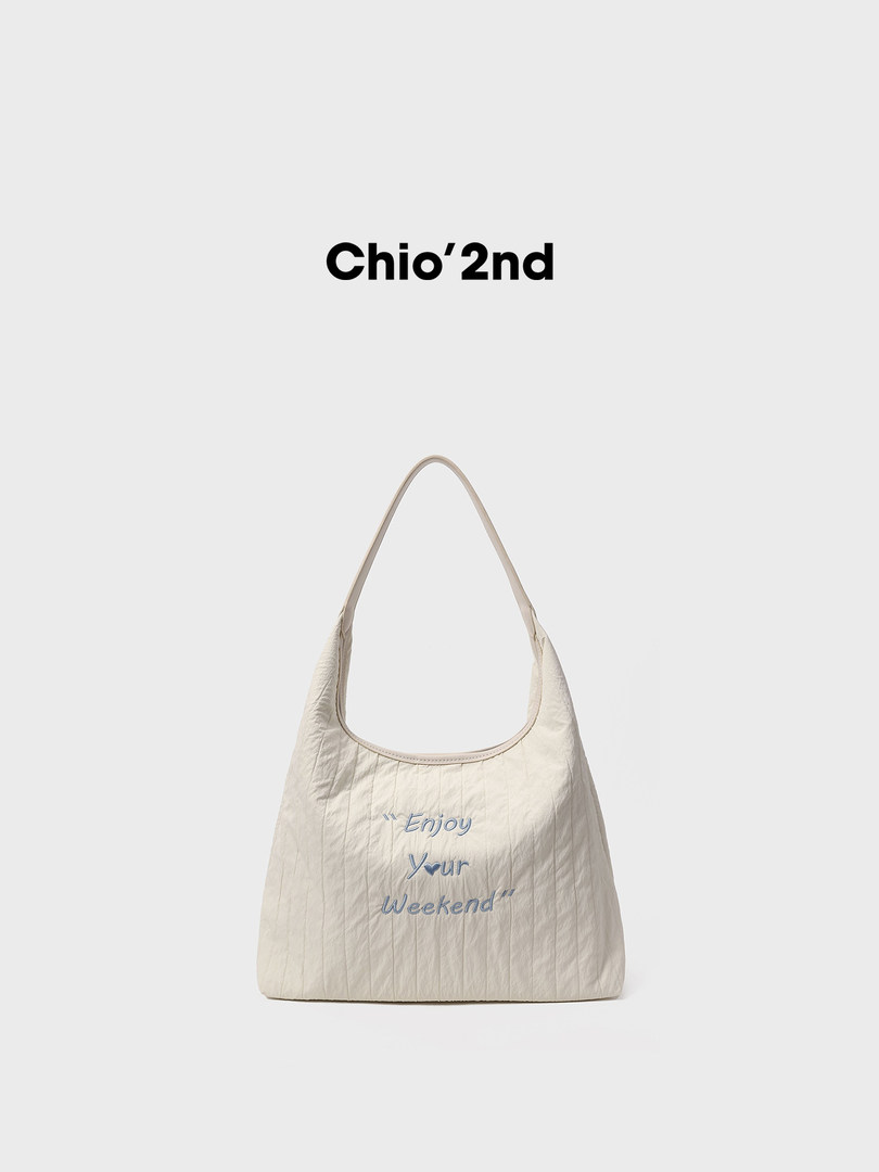 Cream shoulder tote bag with "Enjoy Your Weekend" text on a white background