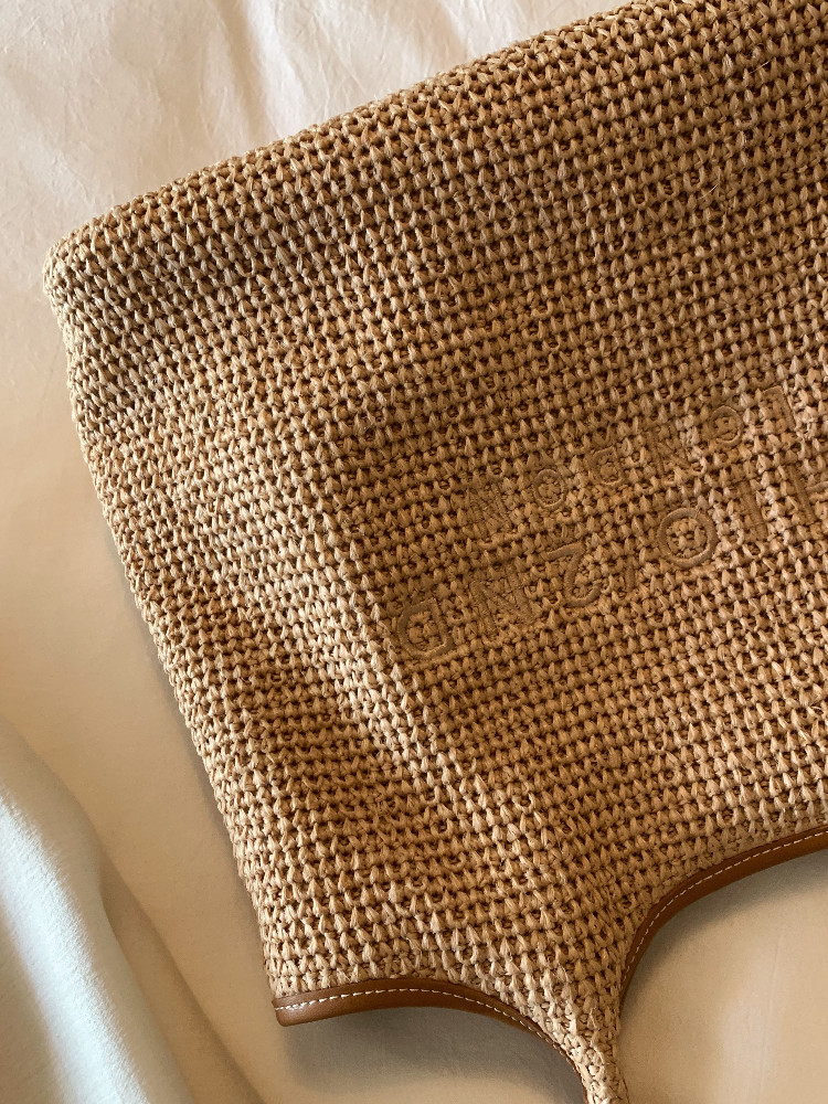 Woven straw tote bag with leather trim