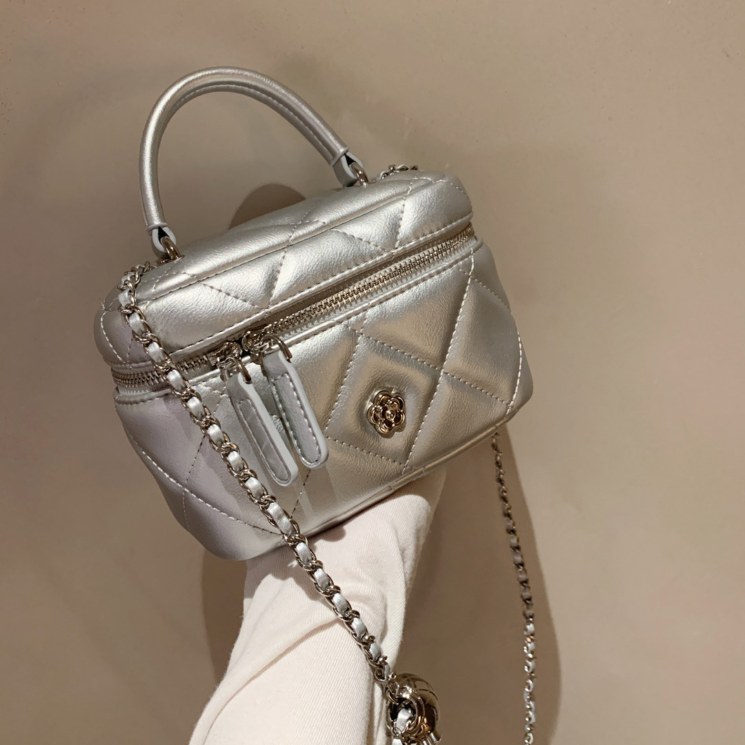 Silver quilted mini handbag with chain strap and top handle