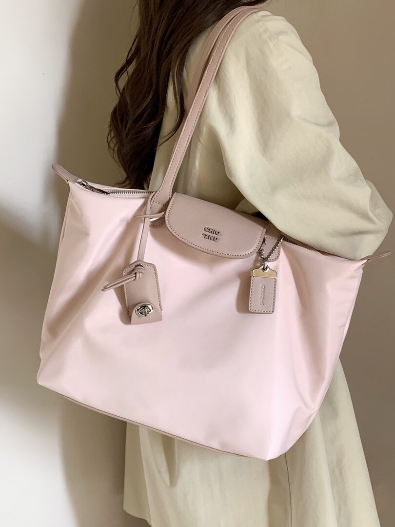 Pink tote handbag worn by a model