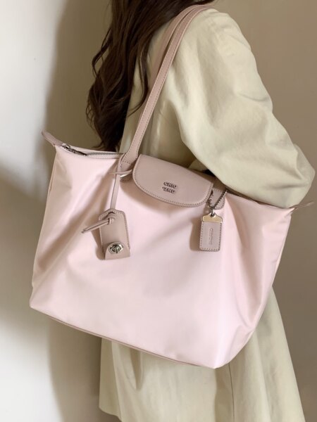 Pink tote handbag worn by a model